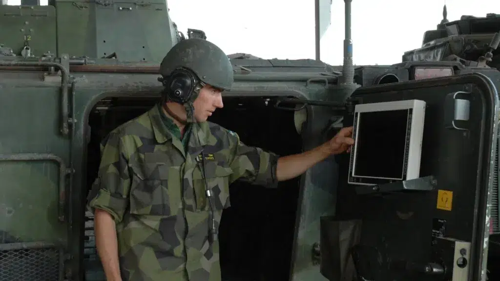 Soldier using an EMI shielding screen connecting to green metallic surface